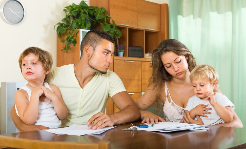 couple and kids looking through visa paperwork for immigration lawyer
